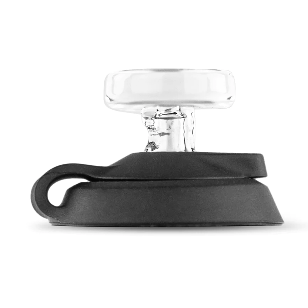 Side profile of the Puffco Proxy Travel Pack showing a clear glass mouthpiece mounted on a low black silicone base against a white background