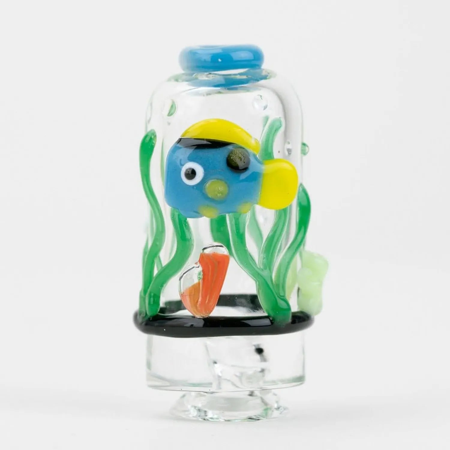 Close-up front view of the Empire Glassworks Puffco Pivot Glass Mouthpiece - Under the Sea showing a small blue and yellow glass fish amid green seaweed inside a clear domed mouthpiece.