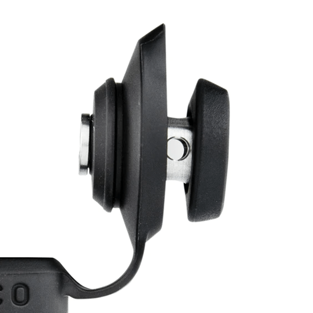 Side-profile close-up of the black Puffco Peak Pro Joystick Cap showing its two rubberized paddle grips and central metal pivot against a white background