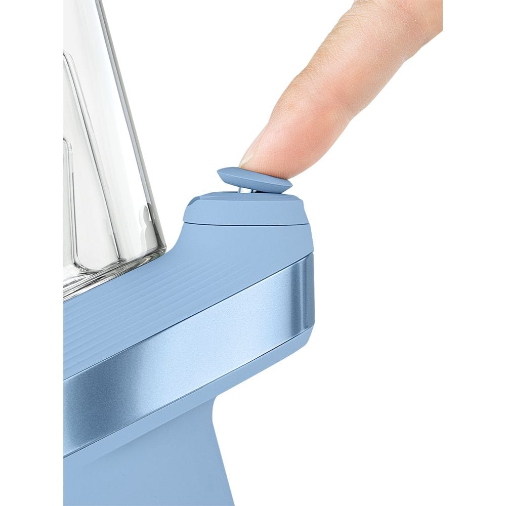 Close-up side view of the Puffco New Peak Vaporizer, showing a hand gripping its metallic body.