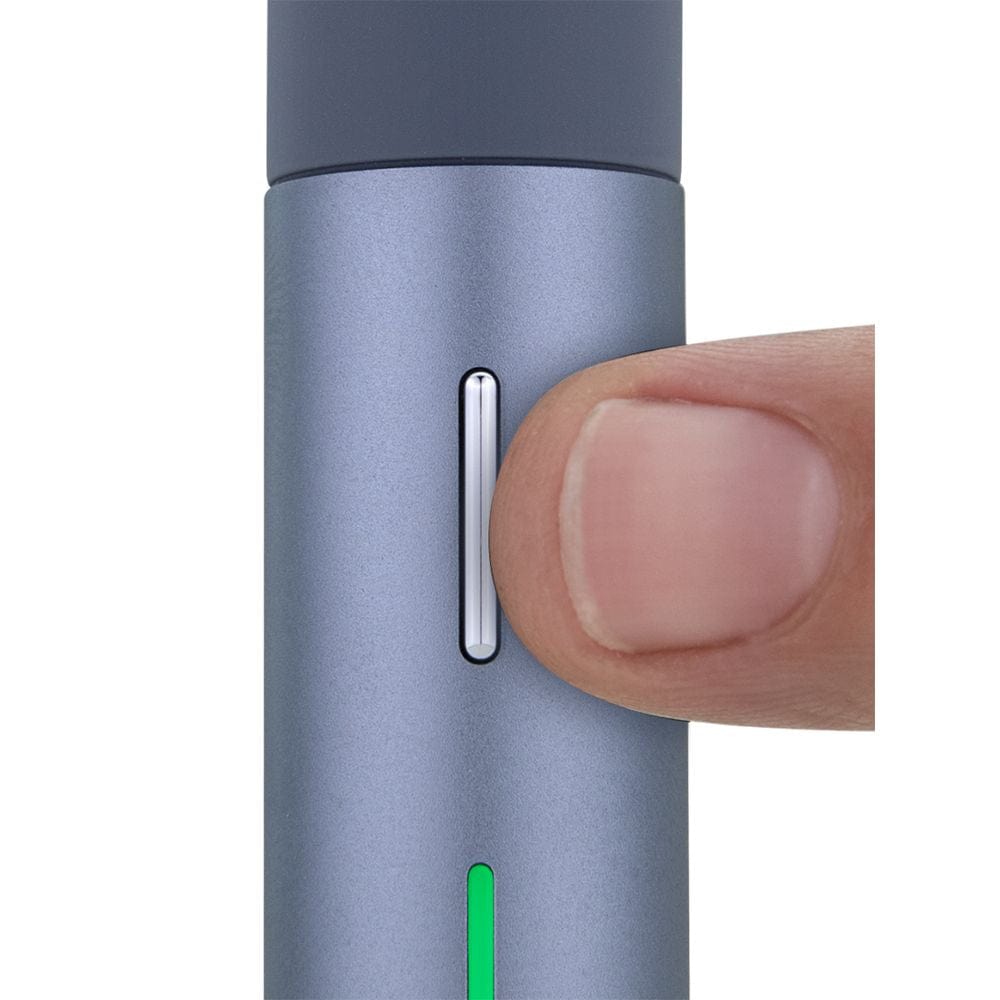 Close-up view of the Puffco Pivot Concentrate Vaporizer, with a finger touching its metallic silver side.