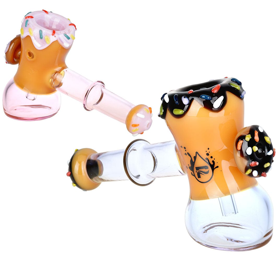A studio shot of the Donut Hammer Bubbler, showing a colorful, frosted glass bubbler with a rounded shape and a small mouthpiece.