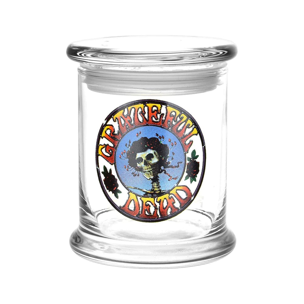 Front view of the Grateful Dead x Pulsar Pop Top 1/2oz Jar, a clear glass container with a rounded top.
