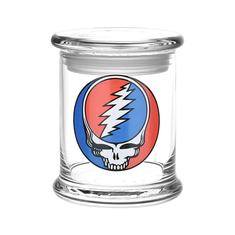 A front view of the Grateful Dead x Pulsar Pop Top 1/2oz Jar, featuring a colorful graphic on its clear glass body.