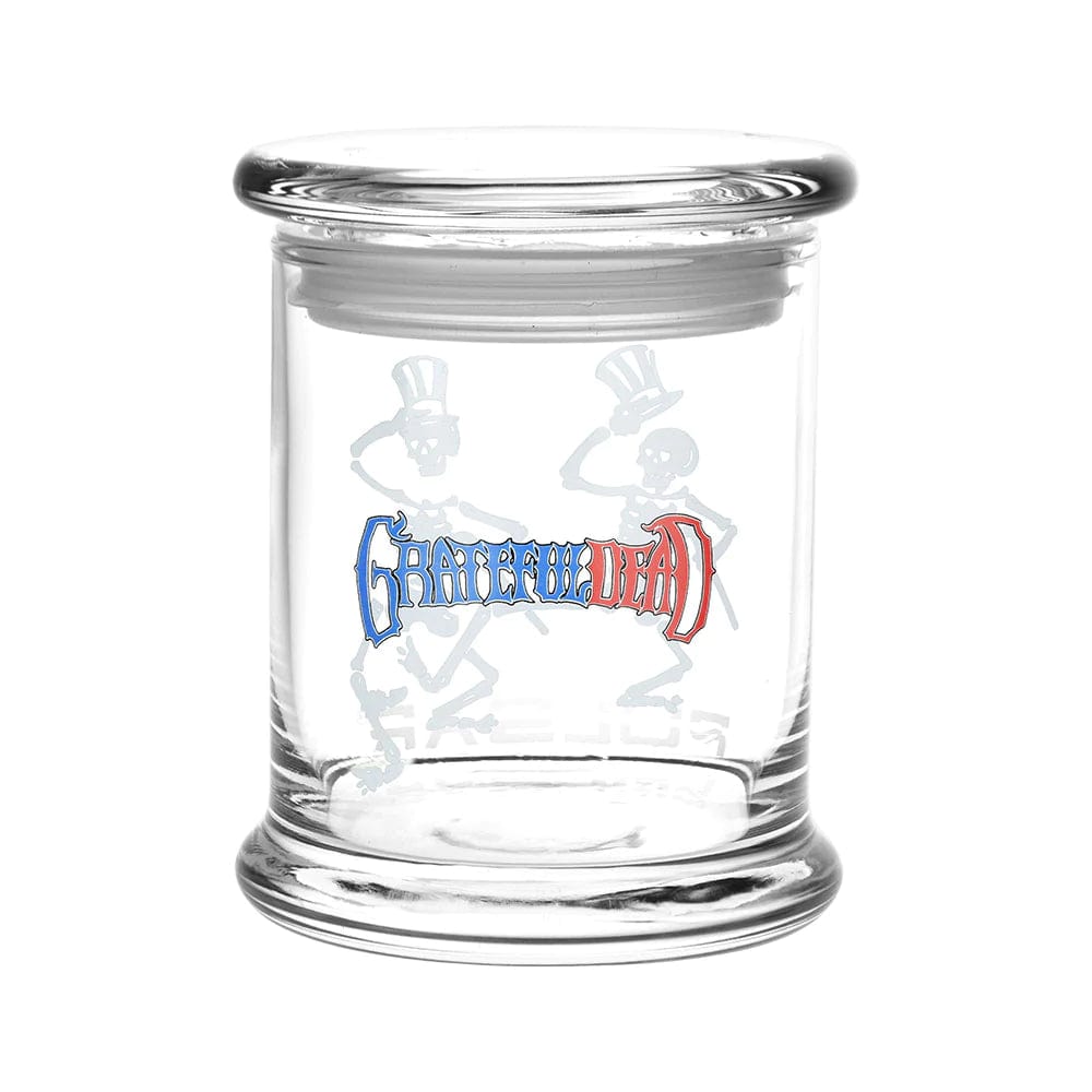 A studio shot of the Grateful Dead x Pulsar Pop Top 1/2oz Jar, showcasing its clear glass construction and simple, cylindrical shape.
