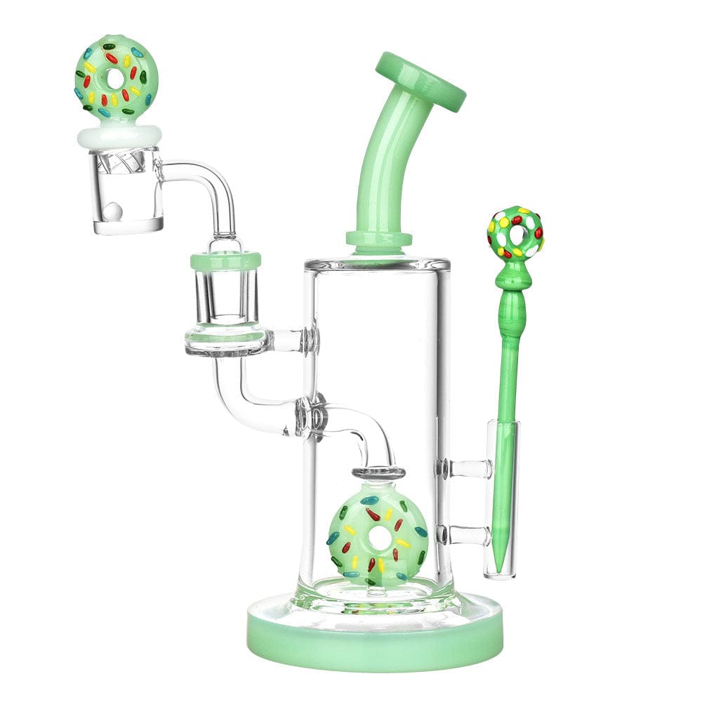 The Sprinkle Donut Dab Rig Set is displayed in a side view, featuring a green glass rig with a colorful donut-shaped accent.