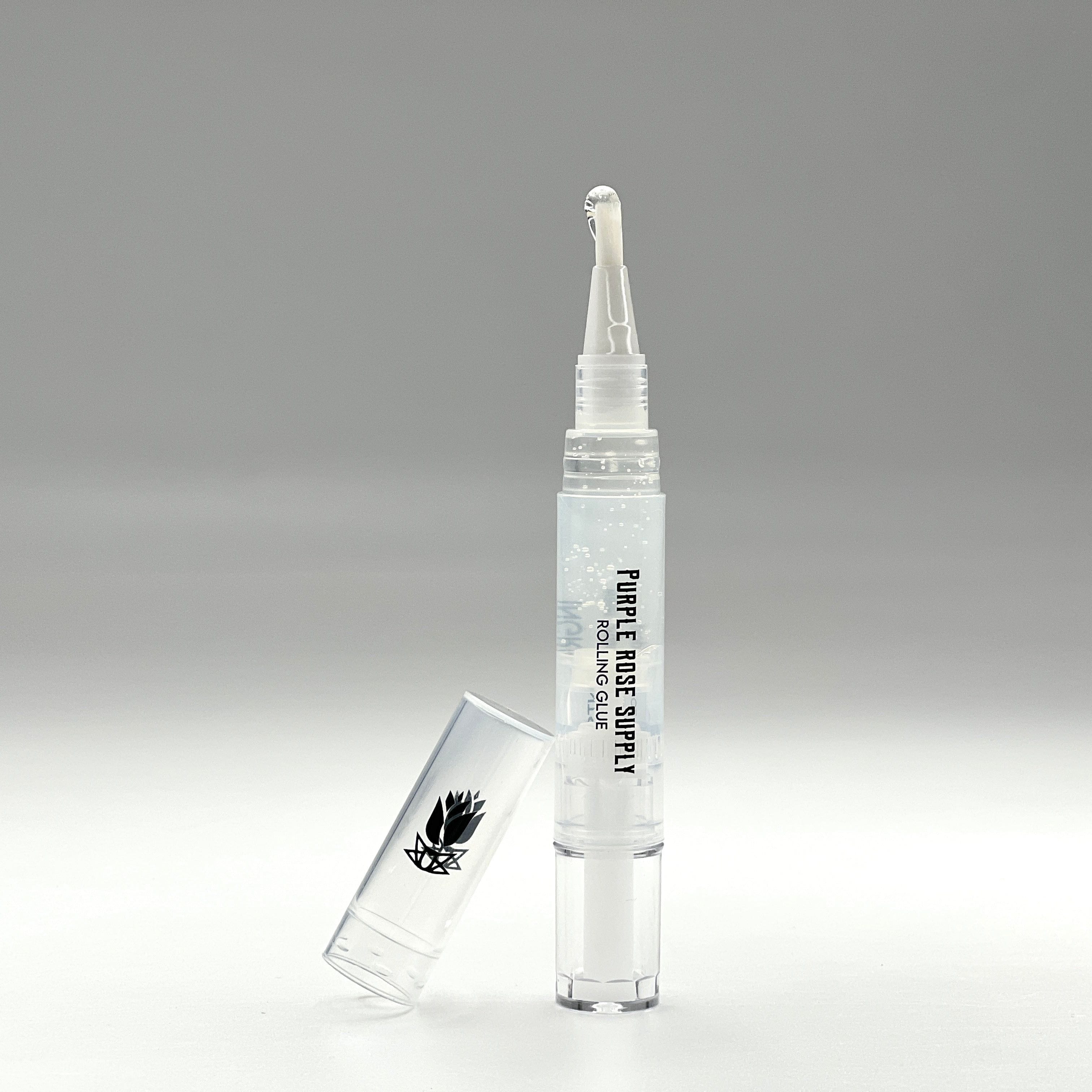 Close-up front view of the Cannagar & Blunt Rolling Glue - 4ml applicator tip with a droplet on the nozzle against a soft gray background