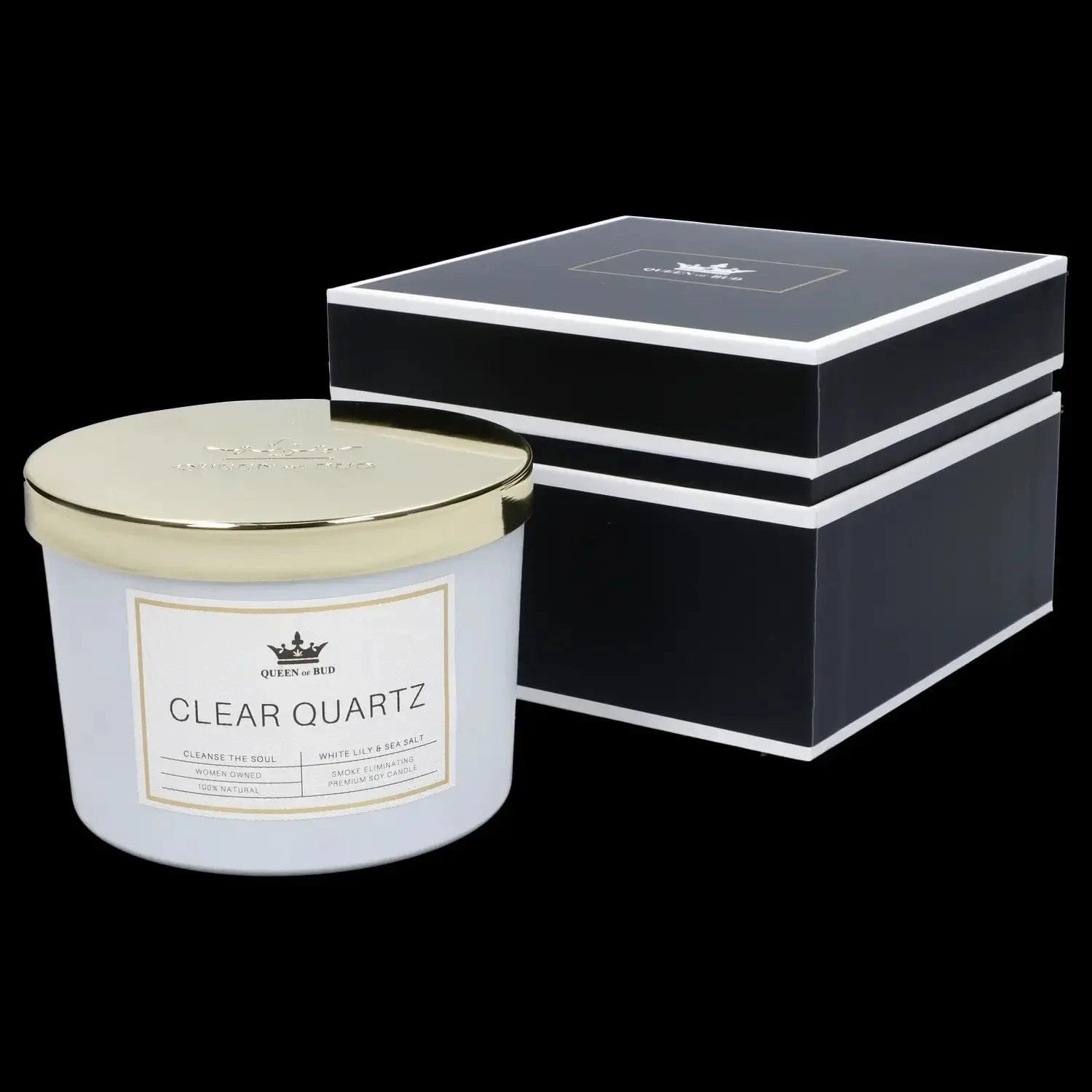 Close-up front view of a white jar and gold lid next to a black gift box, showing the Queen of Bud Candle label.