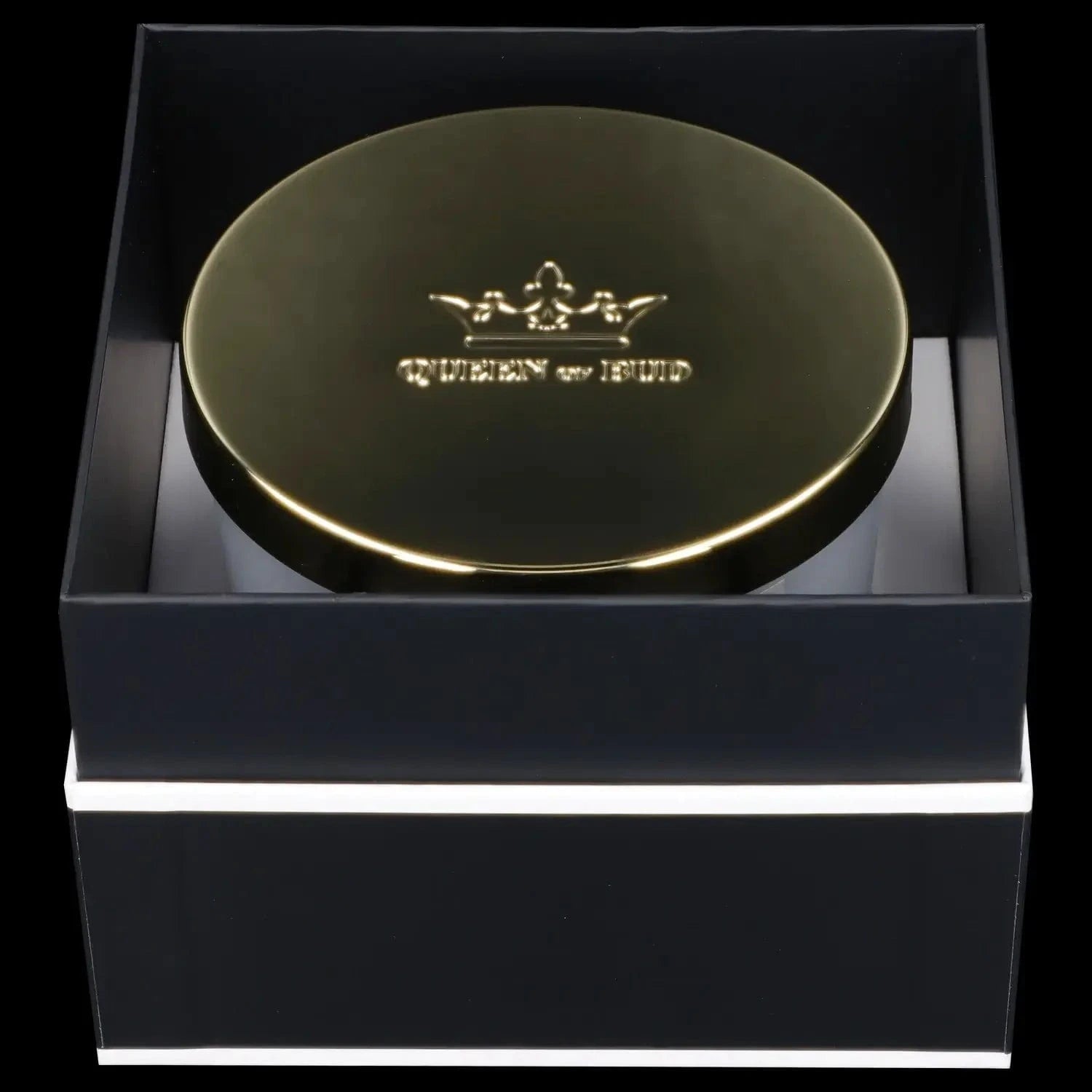 Top-down view of a reflective gold lid embossed with a crown and the words "Queen of Bud Candle" sitting inside a black gift box.