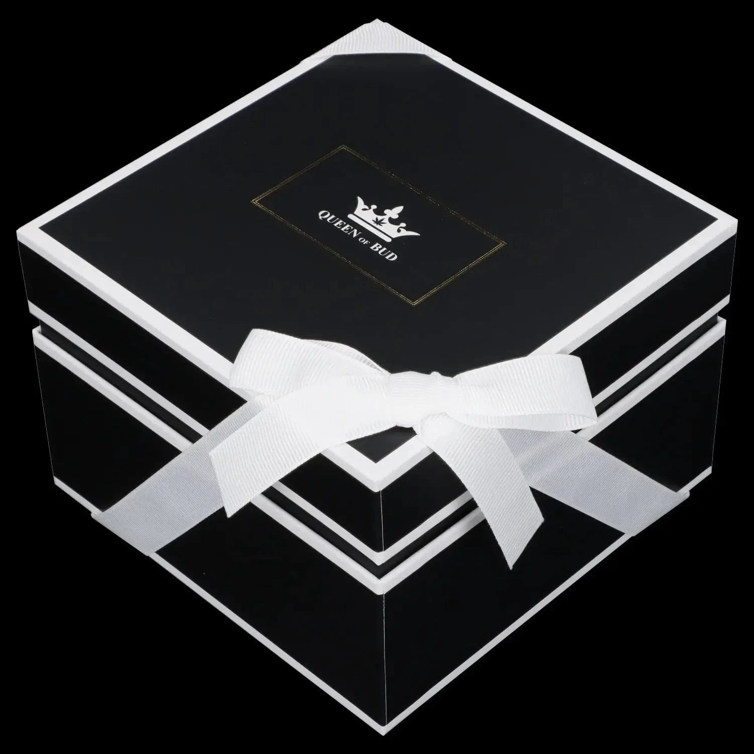 Angled close-up of a black gift box with white trim and bow, showing the Queen of Bud Candle logo centered on the lid.