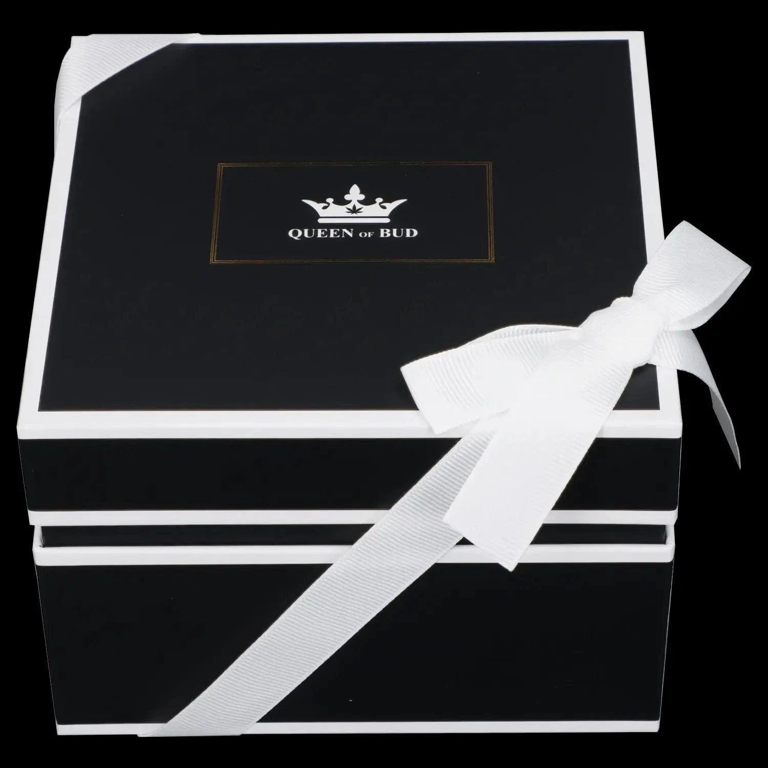 Top-down view of a black gift box with white trim and a large white bow, the lid stamped with a gold-framed crown logo and the words Queen of Bud Candle.