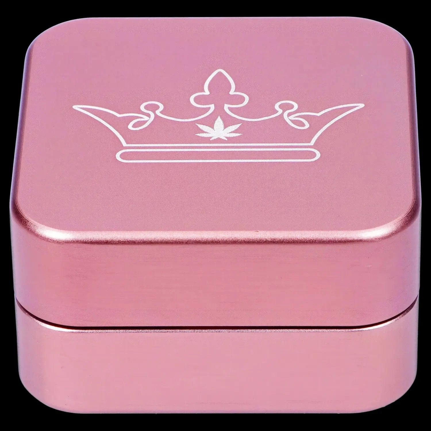Close-up top-down view of the pink QOB 2-Piece Grinder - 55mm showing a white crown emblem centered on its square rounded lid.