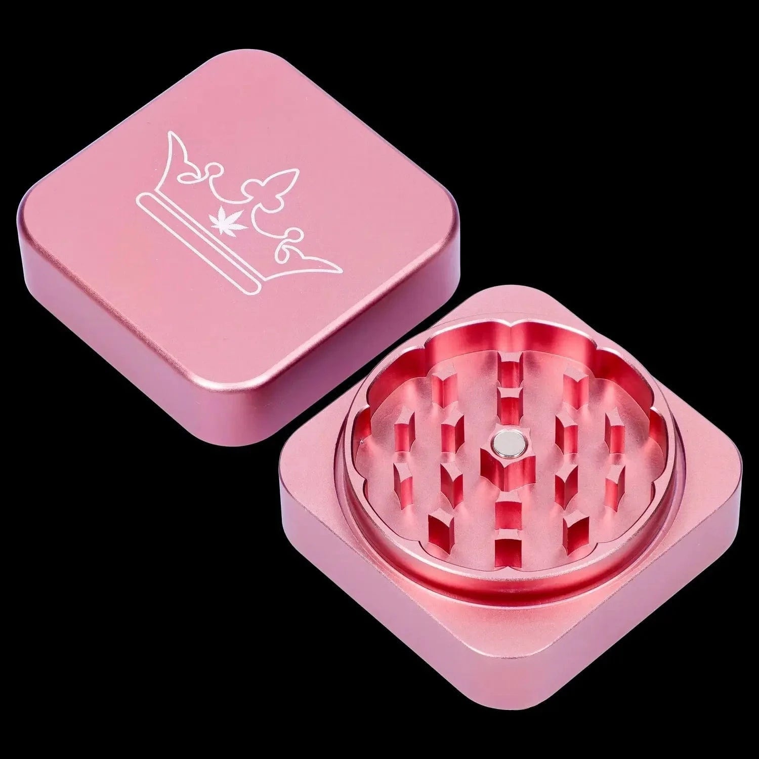 Angled close-up of the pink QOB 2-Piece Grinder - 55mm showing its square lid with crown engraving and flower-shaped teeth.