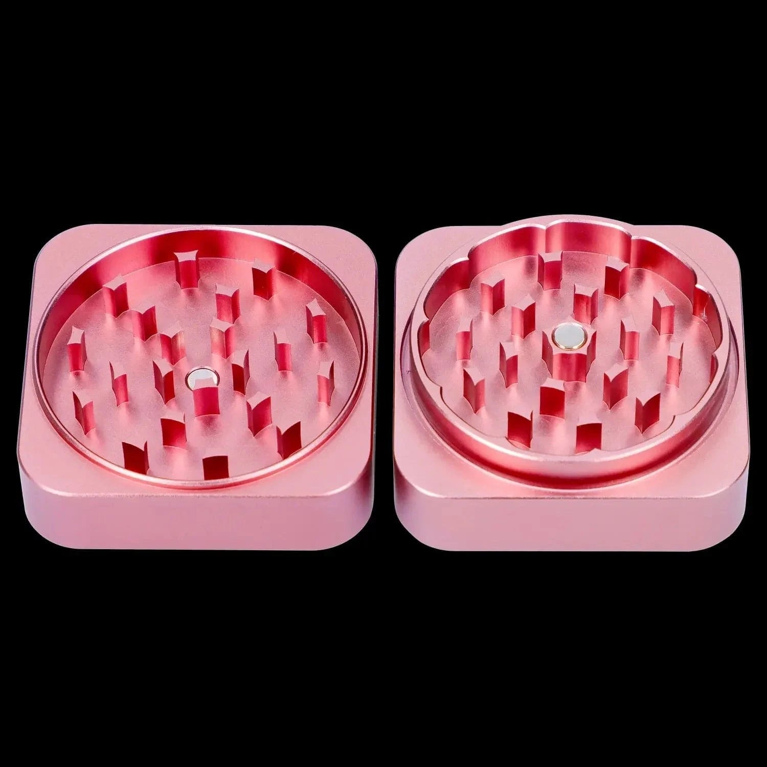 Top-down view of the two open halves of the pink QOB 2-Piece Grinder - 55mm showing staggered diamond-shaped teeth and a central magnet.