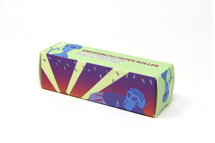 Angled view of the Quik Wikk 78mm Rolling Machine Smoke Bloo Alien box with green, purple and red alien artwork on a white background.