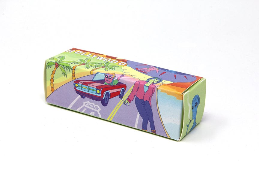 Three-quarter view of a colorful box illustrated with a road trip scene, labeled Quik Wikk 78mm Rolling Machine Smoke Bloo Alien.