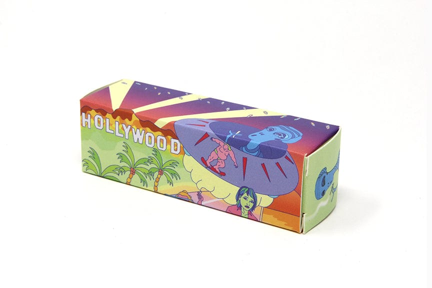 Angled view of a colorful rectangular box labeled Quik Wikk 78mm Rolling Machine Smoke Bloo Alien with a retro Hollywood UFO and palm-tree illustration.
