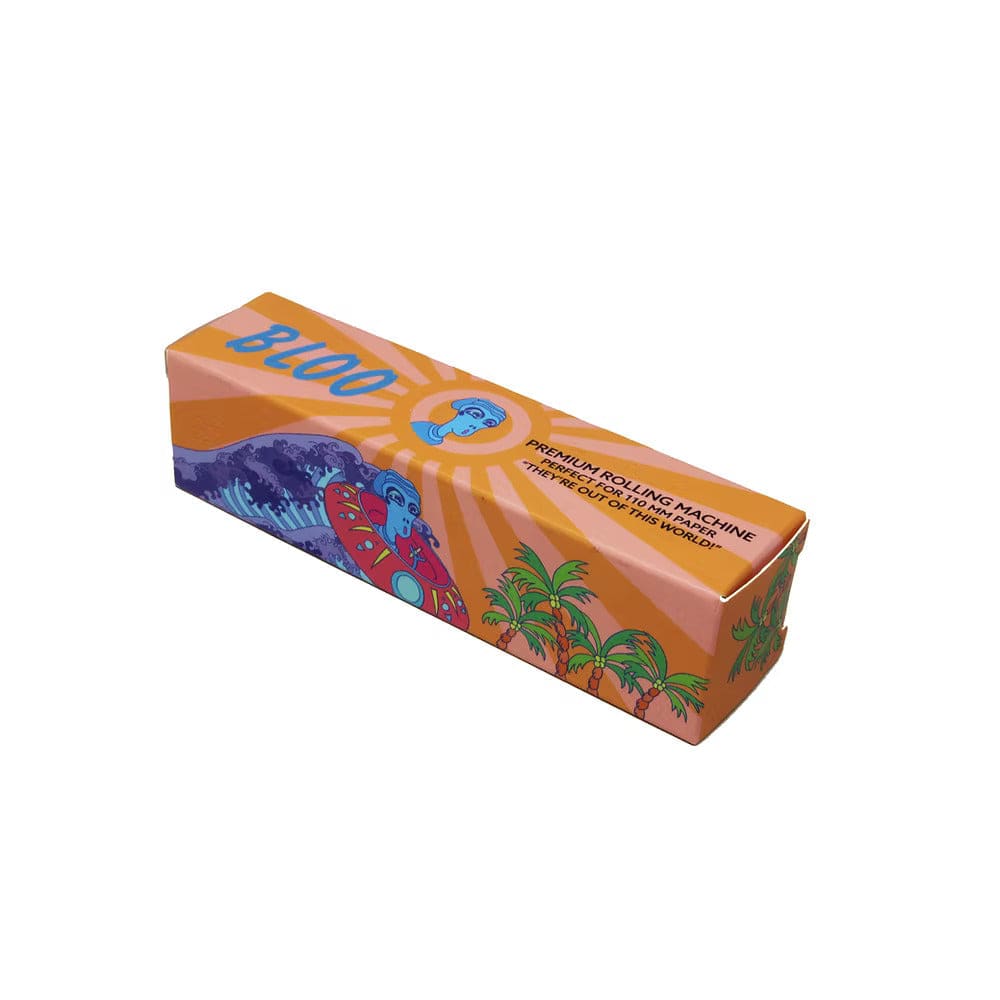 Angled top-down view of the 110mm Rolling Machine Smoke Bloo Alien by Quik Wikk box, showing orange rays, a blue alien motif, palm trees and wave graphics.