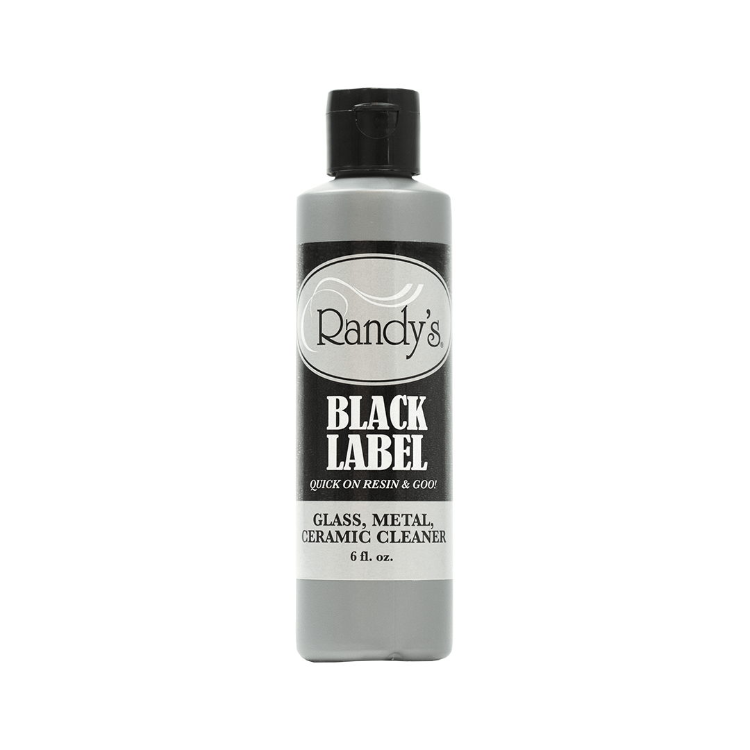 Front view of the Black Label Cleaner bottle against a plain white background, showcasing its label and cylindrical shape.