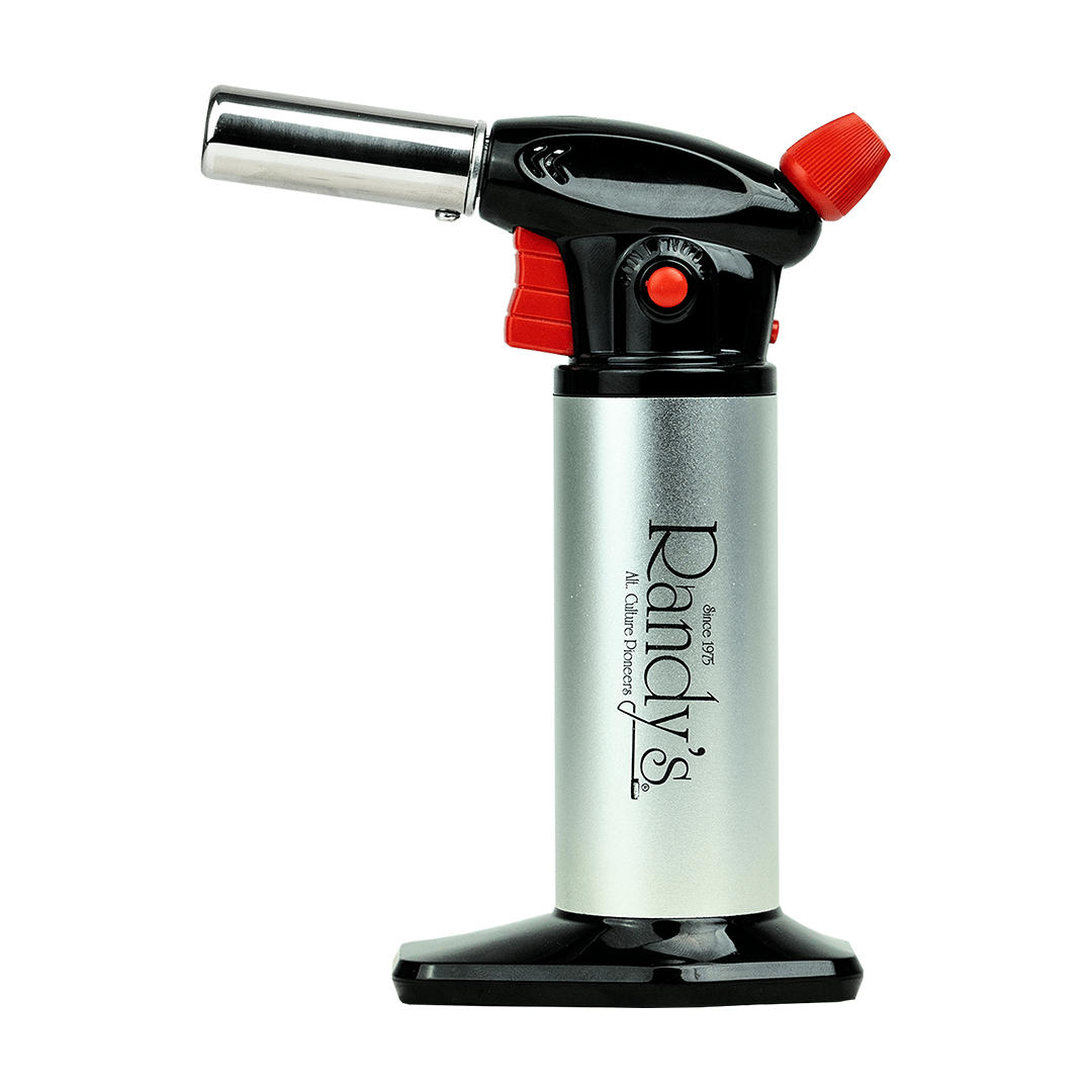 A close-up, angled view of Randy's Torch with a red knob, set against a dark backdrop.
