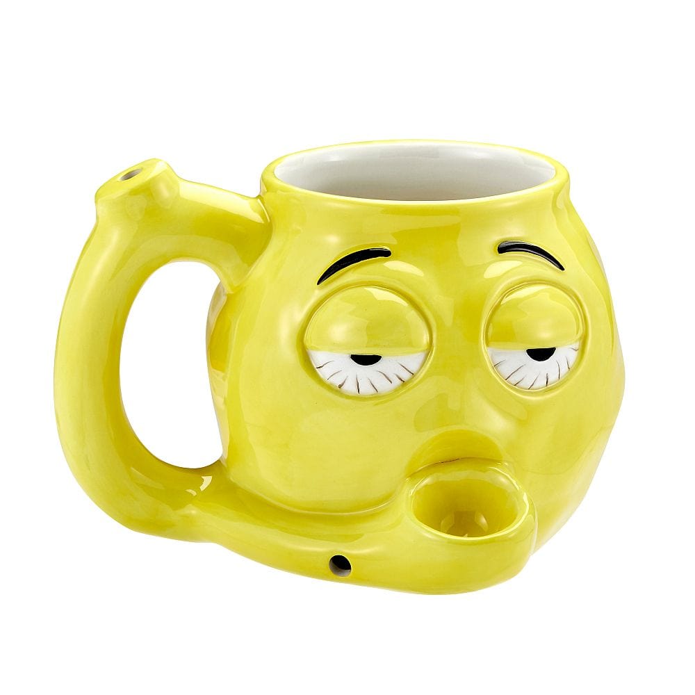 A slightly angled view of the Stoned Emoji Pipe Mug & Stash Jar Bundle, depicting a yellow mug with a smiling emoji face.