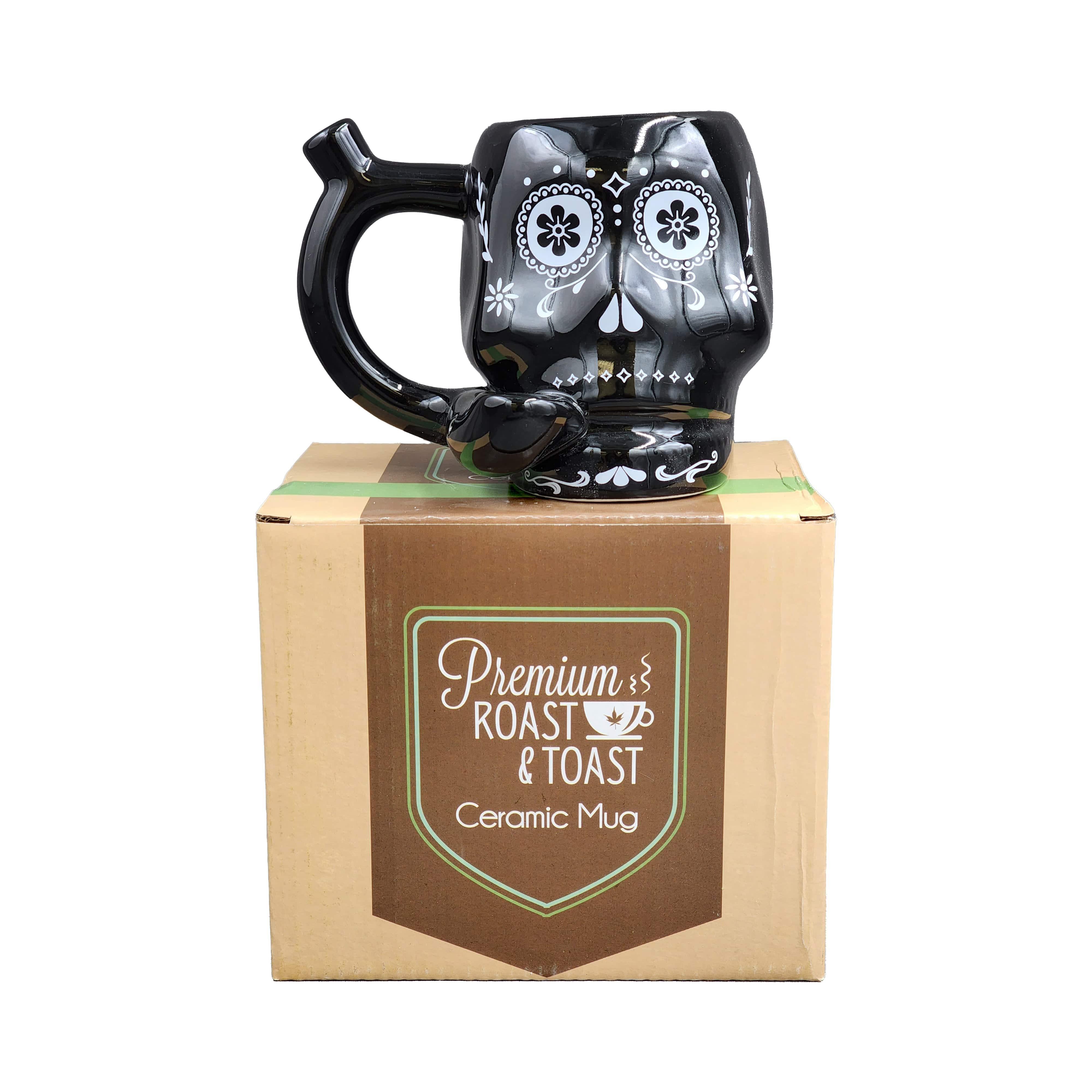 A front view of the Sugar Skull Pipe Mug, showcasing its decorative skull design and handle against a plain backdrop.