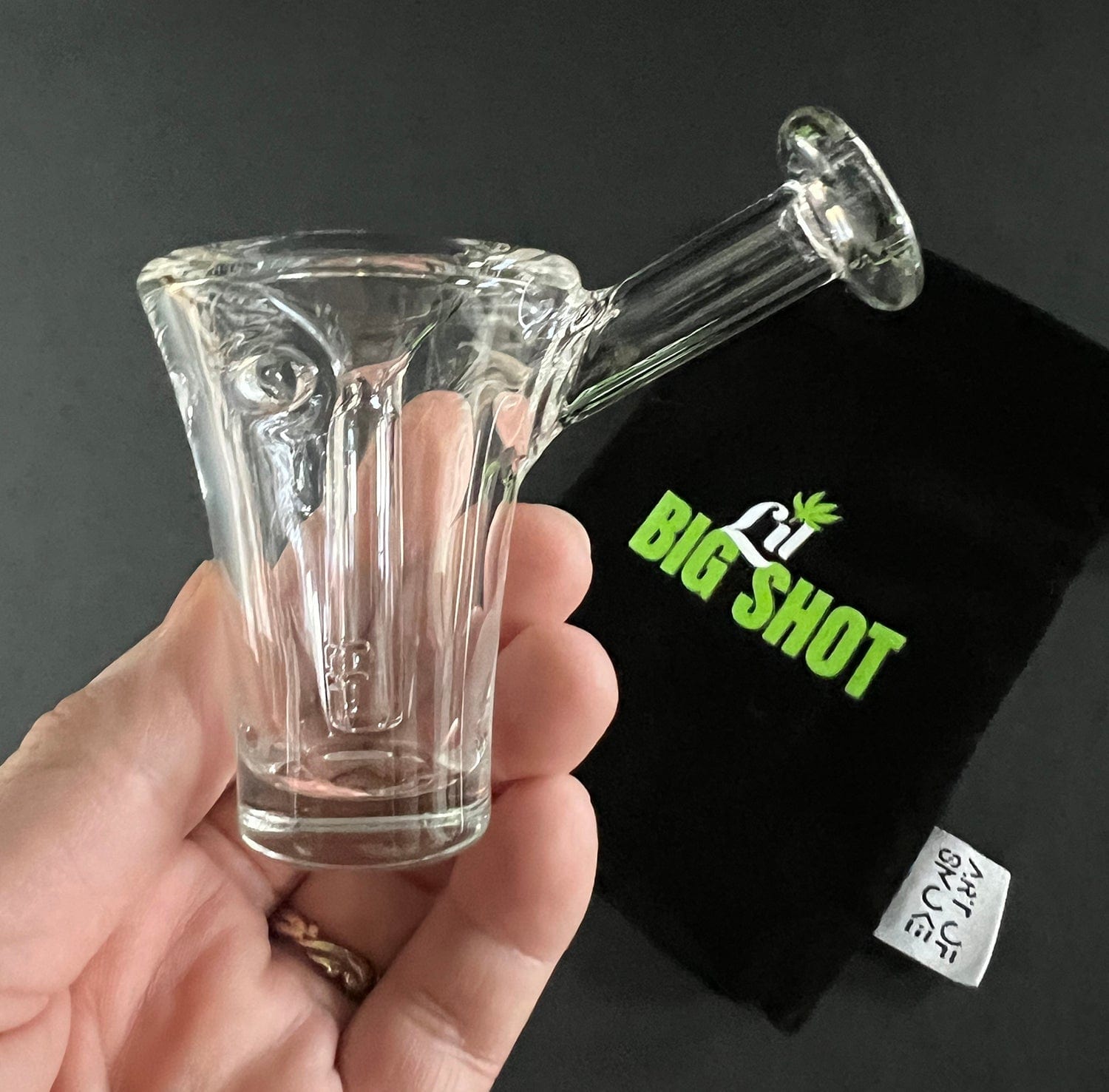 A close-up, angled view of the Lil Big Shot Bubbler, showcasing its clear glass construction and compact size.