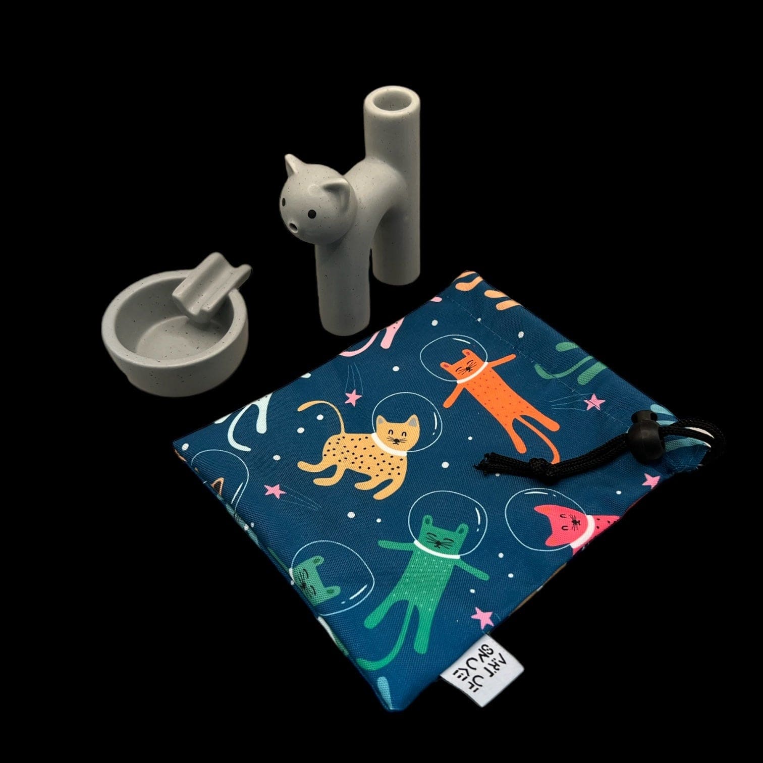 A top-down view shows the Kitty Cat Pipe & Ashtray set on a patterned surface, featuring a whimsical cat design and contrasting colors.