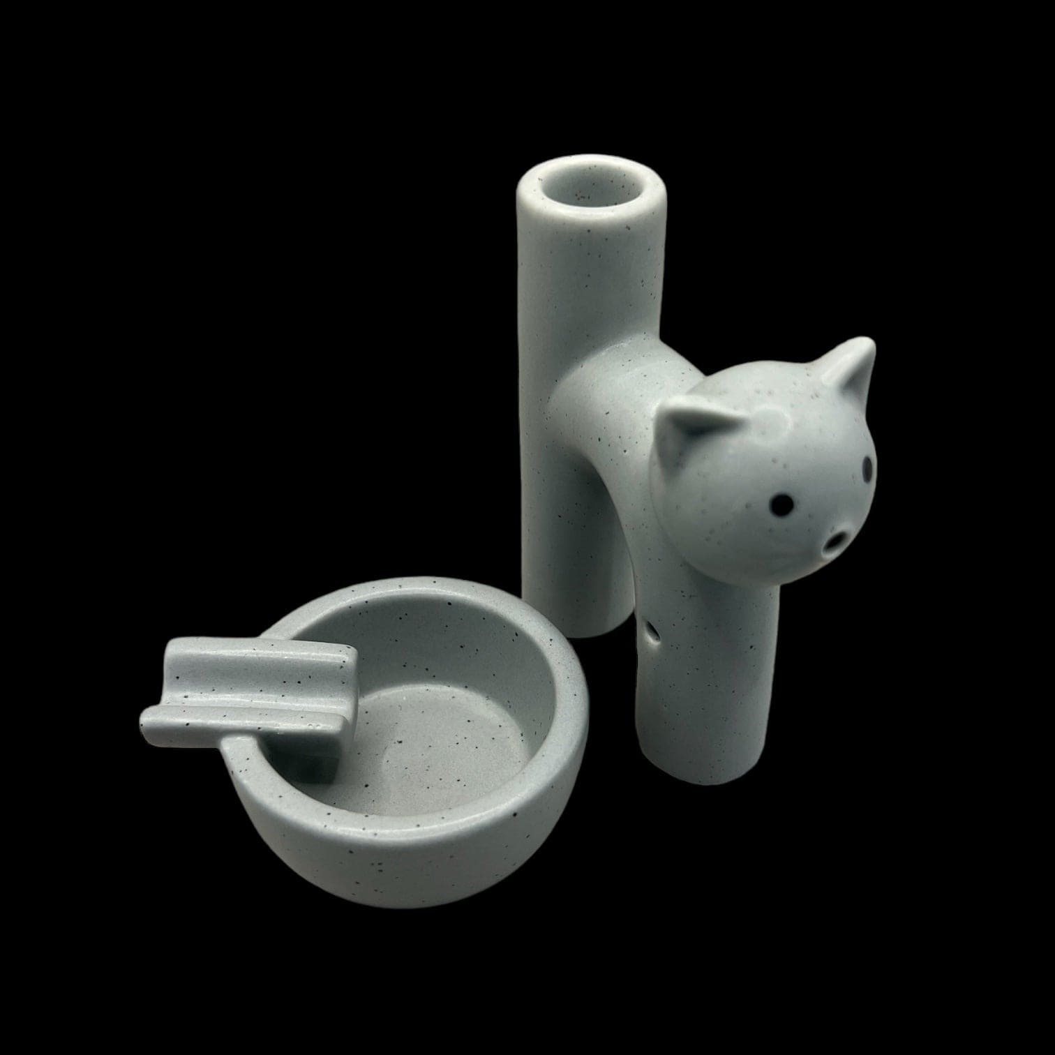 A top-down view of the Kitty Cat Pipe & Ashtray, showcasing the ceramic set's playful design on a neutral surface.