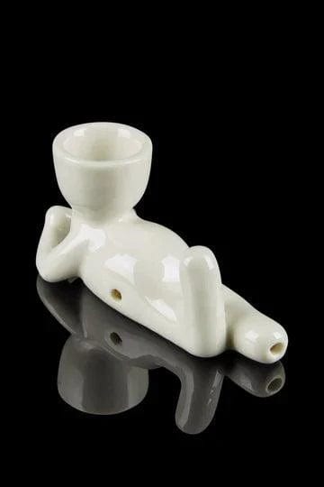 Close-up shot of the Pot Head Pipe, a white ceramic pipe shaped like a head, against a dark background.