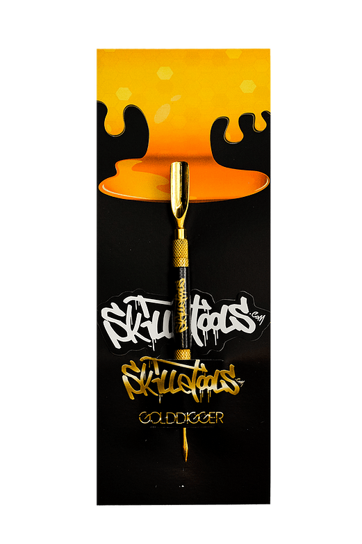 A close-up shot of the Gold Digger Dabber, with a gold tip against a dark, textured background.
