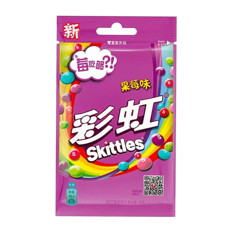 A brightly lit, angled shot of Skittles - Wild Berry Candy packaging with Chinese characters and colorful graphics.