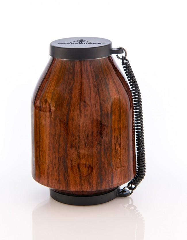 Front view of the Smoke Buddy Personal Air Filter, a cylindrical device with a black base and patterned exterior, set against a bright white background.