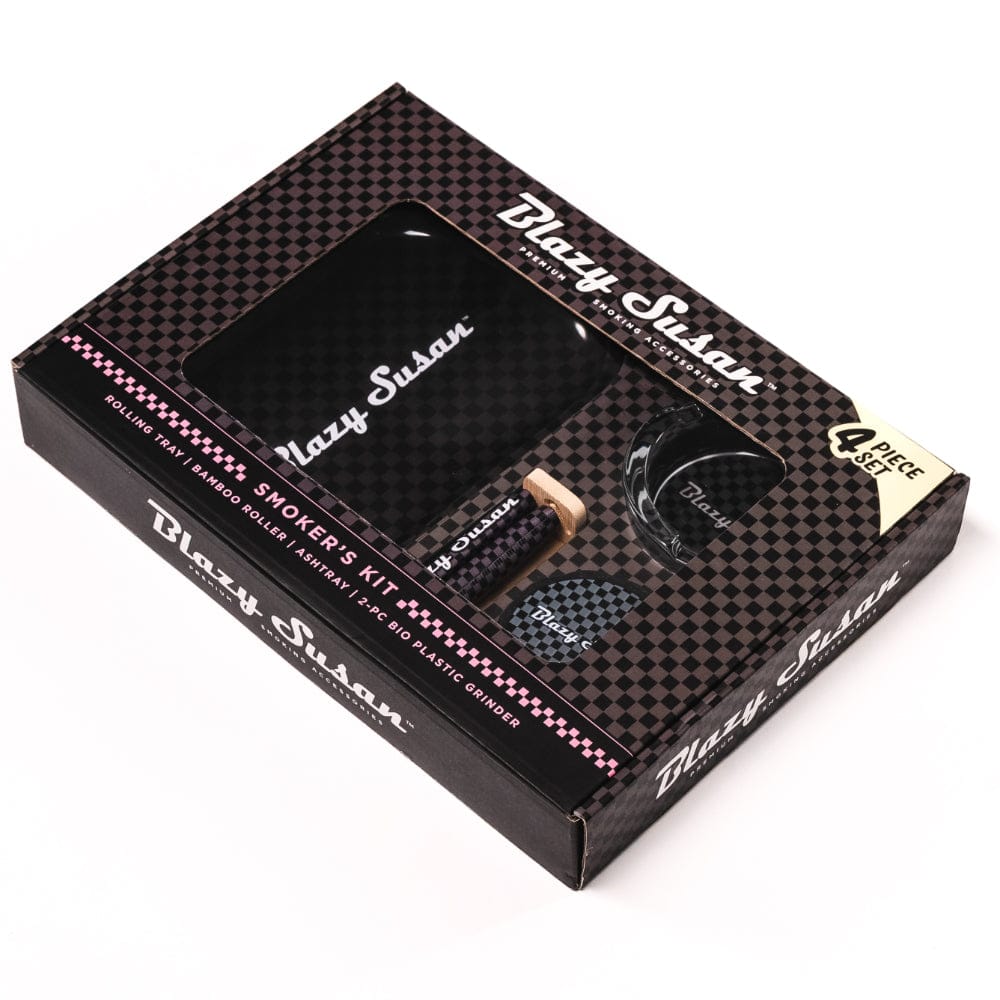 Angled top-down view of the boxed Blazy Smoker's Kit with checkered black packaging and a window showing tray and accessories.