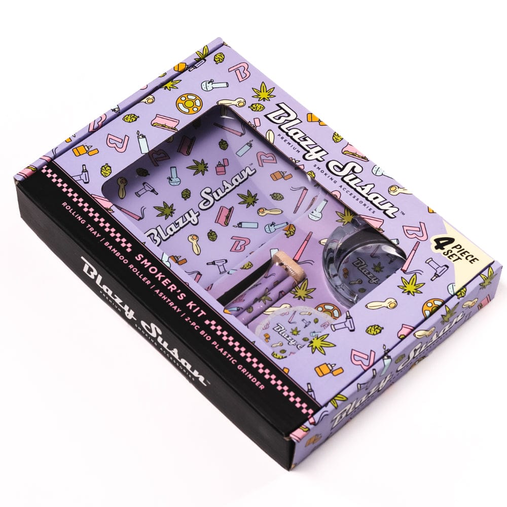 Angled top view of the purple Blazy Smoker's Kit in patterned packaging, showing the tray, grinder window and accessories inside.