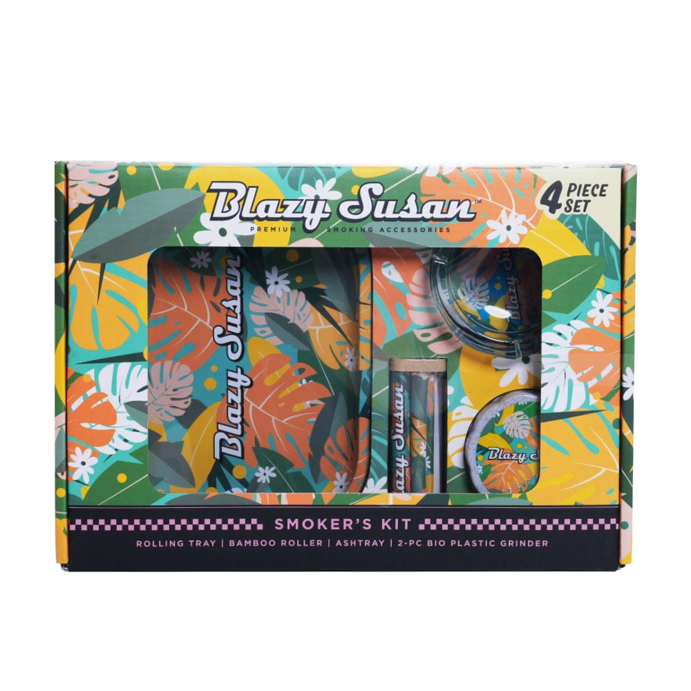 Front-facing shot of the colorful tropical-patterned Blazy Smoker's Kit displayed in its windowed box showing tray, roller, ashtray, and grinder.