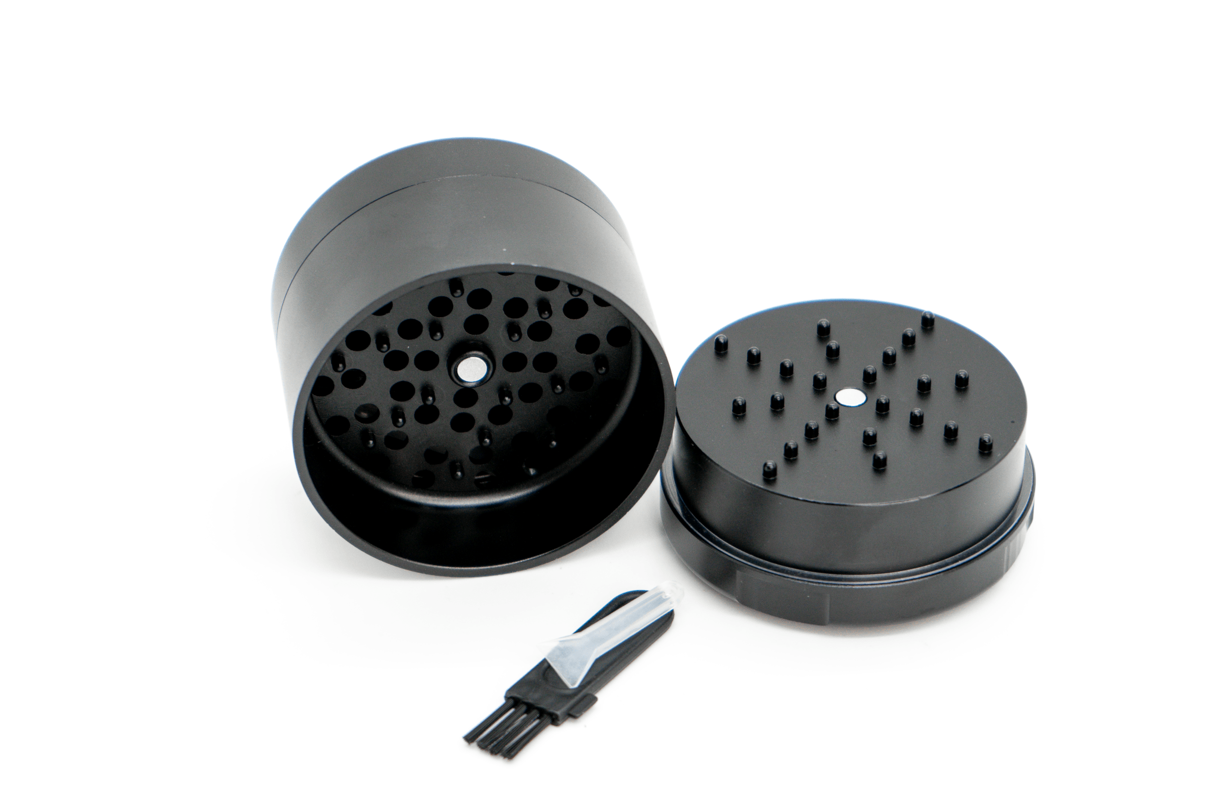A top-down view of the disassembled 3-piece Grynder (N.Y.A.G) showcasing its inner components against a stark white background.