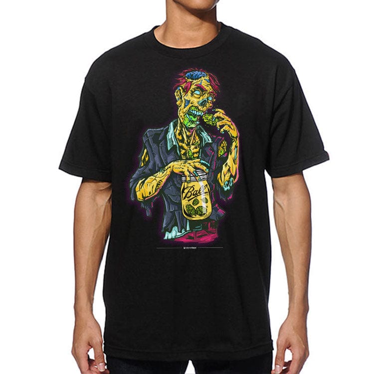 Front-facing view of a model wearing a black Zooted Zombie Tee featuring a neon-colored zombie holding a mason jar and eating a brain.