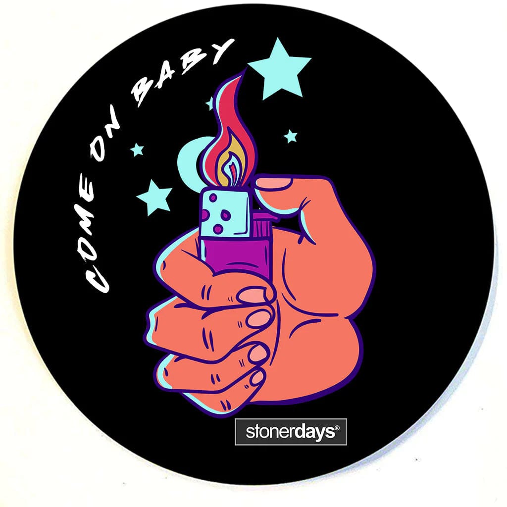 A top-down view of the Stonerdays Round Dab Mats featuring a hand holding a lighter surrounded by white stars on a black background.