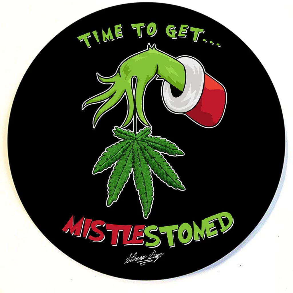 Holiday Themed Dab Mats feature a detailed illustration of cannabis leaves arranged around bold, festive lettering.