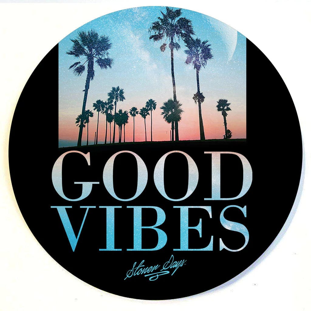 A vibrant, top-down view of the Stonerdays Round Dab Mats, featuring a sunset and palm trees against a bright sky.