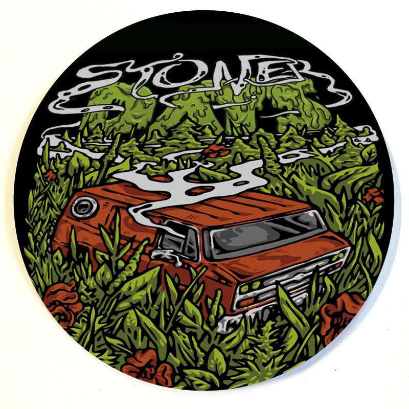 A close-up, overhead view of the Stonerdays Round Dab Mats featuring a vintage car surrounded by illustrated green foliage.