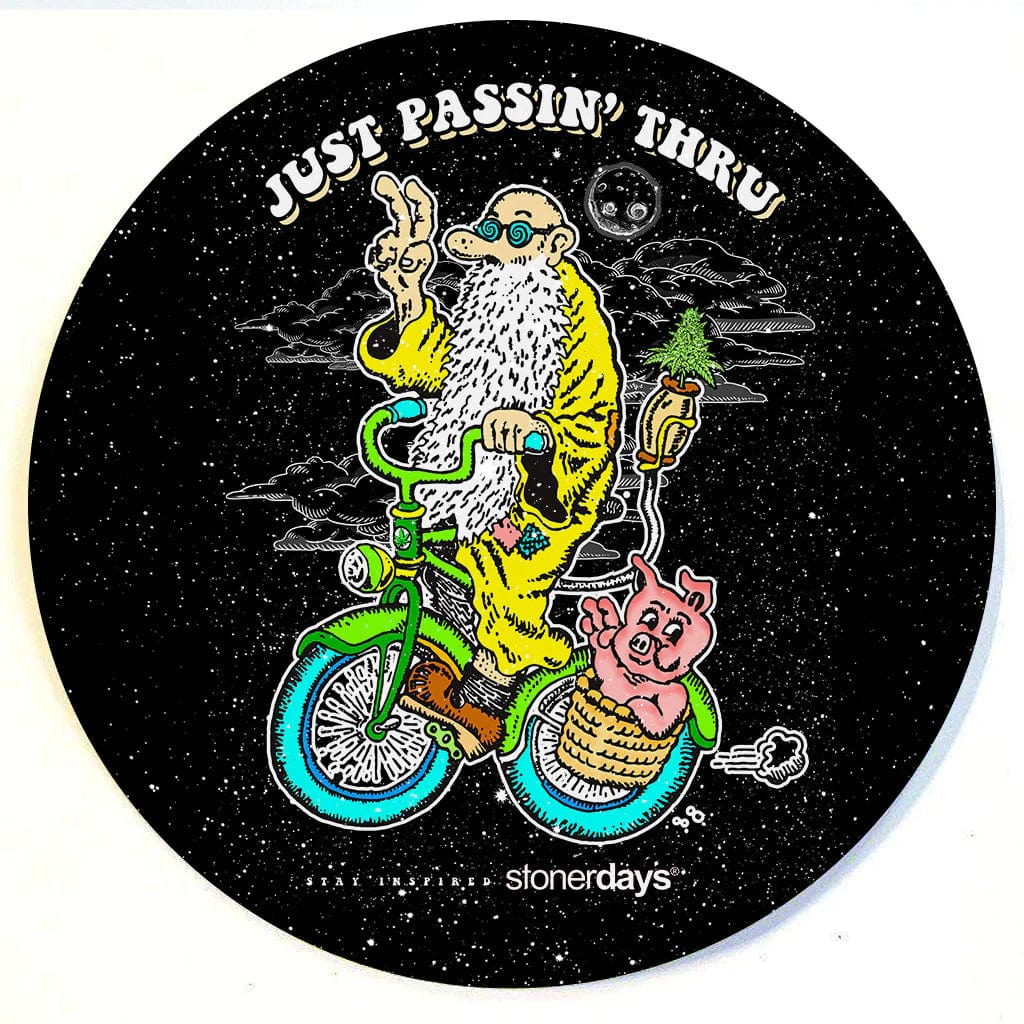 A detailed illustration on the Stonerdays Round Dab Mats shows a pig riding a bicycle through a starry night.