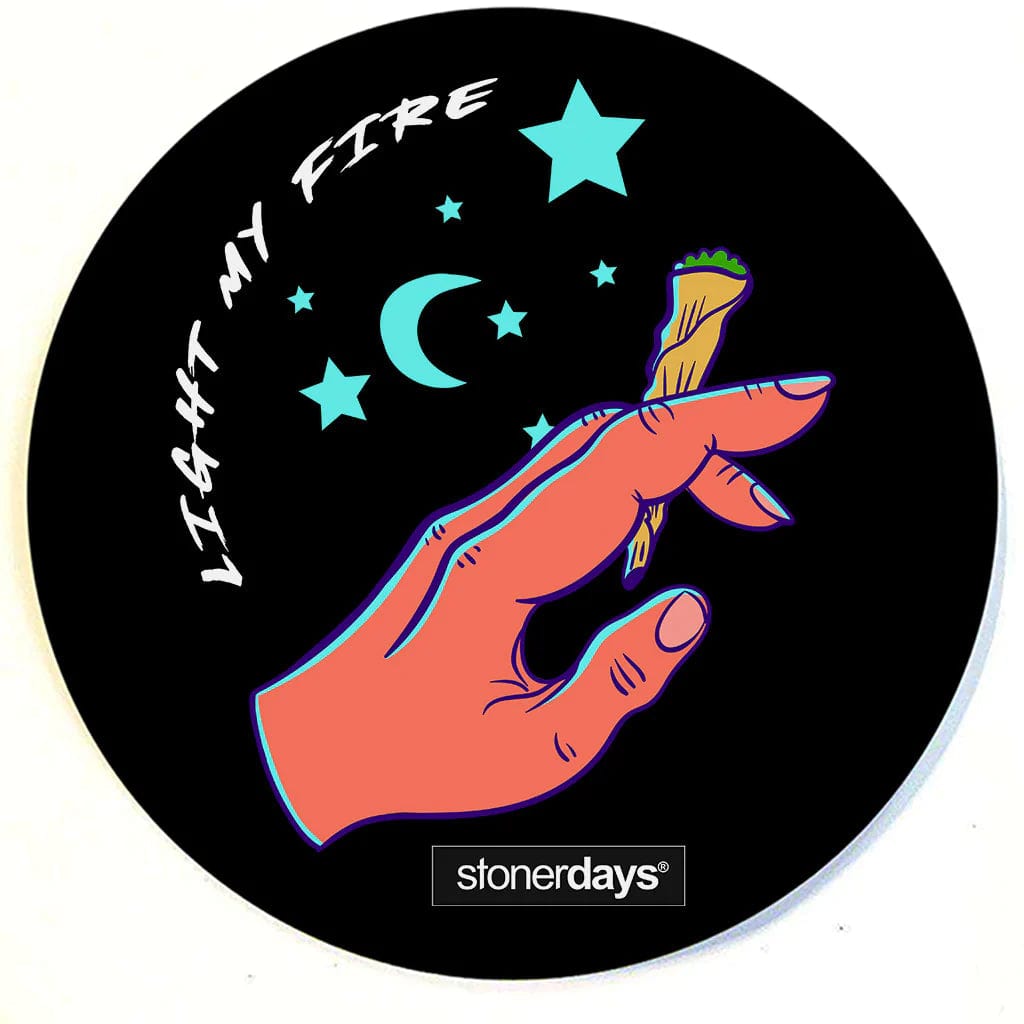 A top-down view of the Stonerdays Round Dab Mats featuring a hand making a pinching gesture amidst scattered stars.