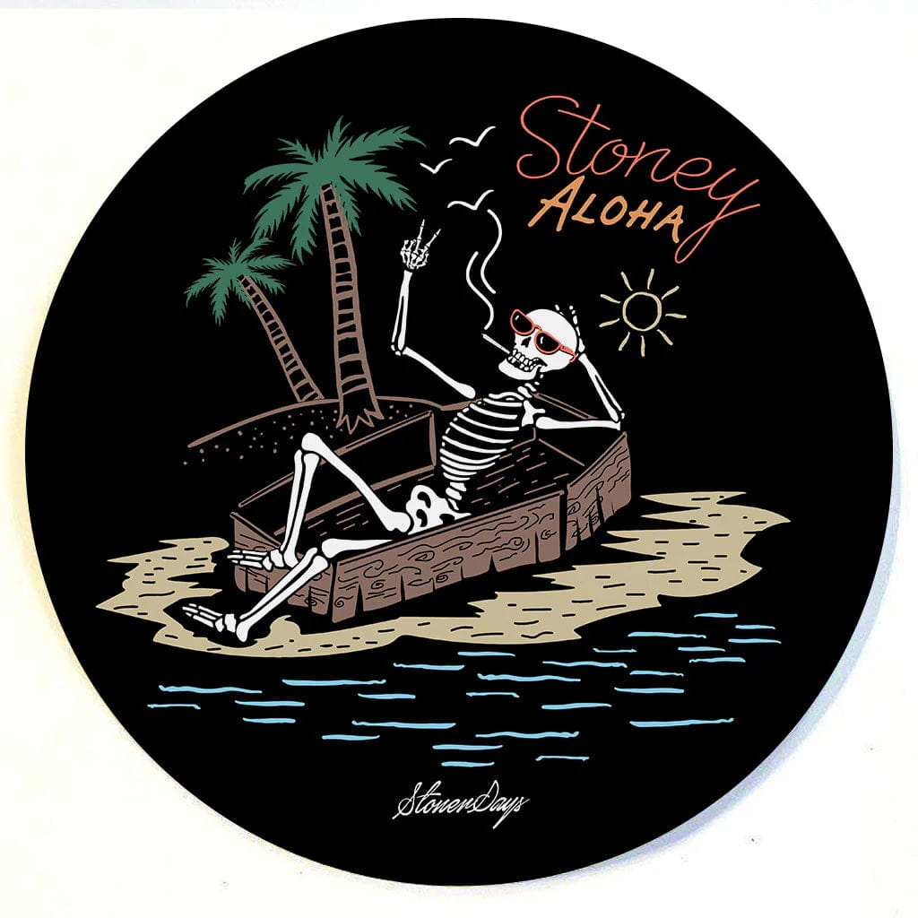 A top-down view of the Stonerdays Round Dab Mats featuring a skeleton lounging beneath a palm tree.