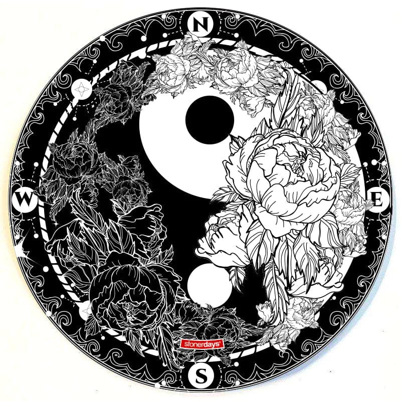 A top-down view of the Stonerdays Round Dab Mats, featuring a compass rose design with ornate black and white details.