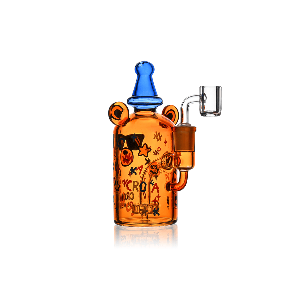 Center-front view of the Croia Glass Cool Teddy Bear Dab Rig with Showerhead Perc, an amber glass bear-shaped rig with blue hat top and clear banger against a white background