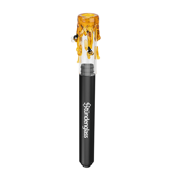 Centered vertical shot of the Stündenglass Hose Tip Save the Bees showing a black shaft topped by a clear glass tip with dripping amber "honey" and tiny bee accents