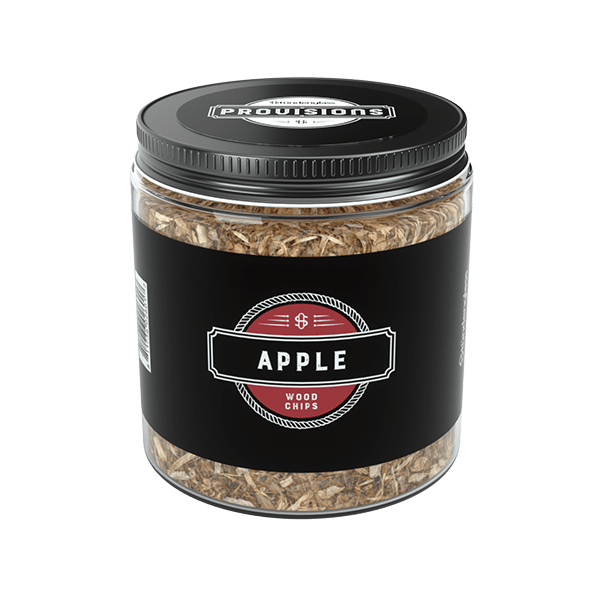 Angled front view of a clear jar of Woodchips - Apple (4oz) showing light brown apple wood chips through the glass and a black label with red badge.