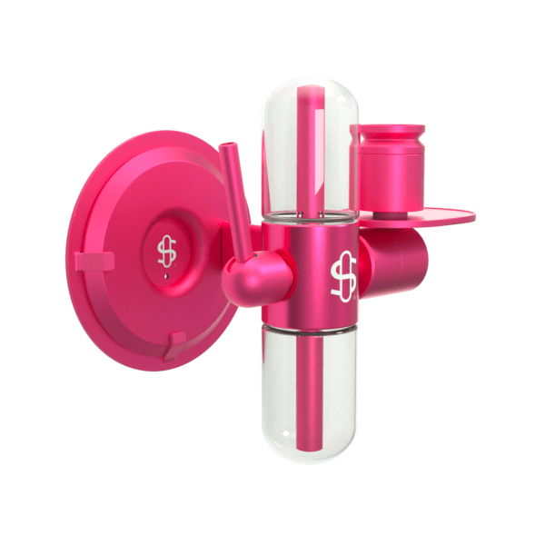 Angled view of the bright pink Kompact Wall Mount (Pink) attached to a white background, showing its round base, cylindrical reservoir and small shelf.